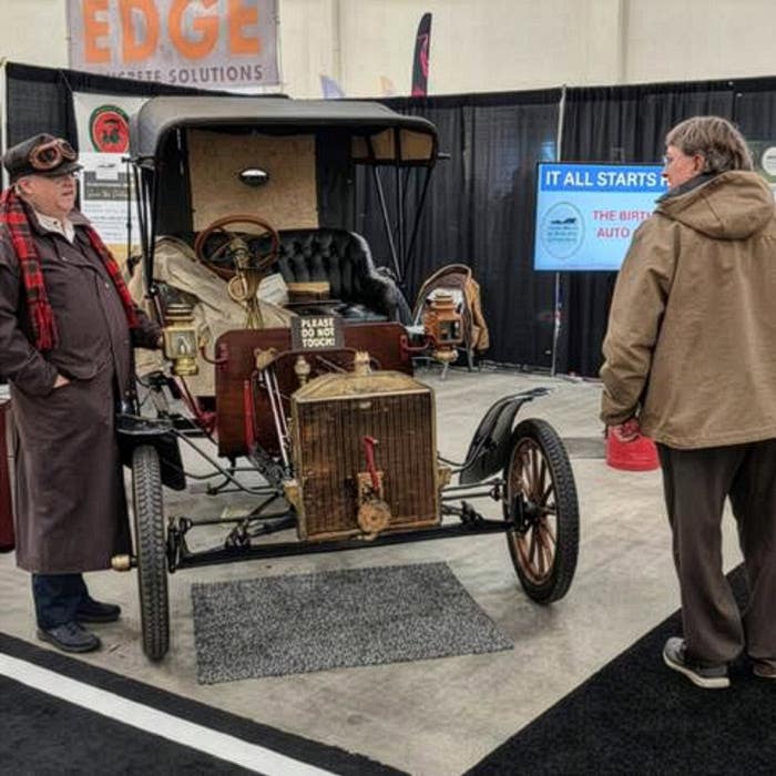 The 1906 Ford Model N recently showcased at the Michigan International Auto Show as part of introducing the Museum of the Horseless Carriage to the public. An unknown guest interacts with Jay Follis, Building Committee Chairman of the Museum of the Horseless Carriage, dressed in era-correct garb.